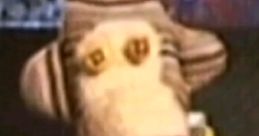 Sock puppet character dressed in a suit, popular in Retrolam TikTok videos, adding humor and nostalgia to the platform.