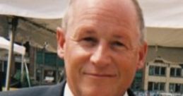 Paul Steigerwald smiling in a professional suit, showcasing his approachable demeanor at a public event.