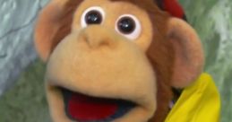 Cheerful monkey puppet in a yellow raincoat and blue backpack, ready for fun adventures in "Monkey (Milkshake!).