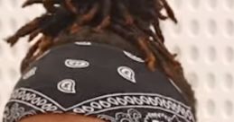 Close-up of KSI expressing emotion, wearing a black bandana against a neutral background, showcasing hyper-realistic detail.