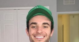Smiling man in a tank top and green cap, showcasing a healthy lifestyle and positive energy. Perfect for Sambucha promotion.