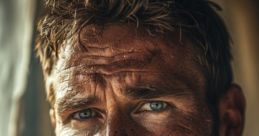 Intense close-up of a rugged man with blue eyes and a beard, conveying emotion and strength in a natural setting.