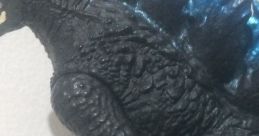 Detailed figure of a talking Godzilla, showcasing intricate scales and vibrant blue spines against a neutral background.