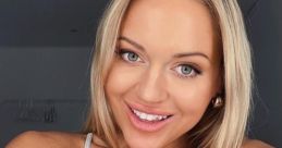 Erna Husko poses with a bright smile in a casual gray tank top, showcasing her confident personality and striking features.
