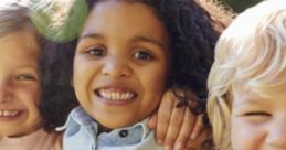 Three cheerful kids smiling closely together outdoors, enjoying friendship and sunny moments in a joyful atmosphere.