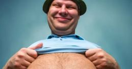 Smiling man lifting his shirt to reveal a round belly, wearing a green hat against a blue background.