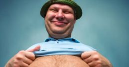 Smiling man lifting shirt to reveal belly, showcasing body positivity and humor in a relaxed setting. Cm 23 8 25 3 themes.