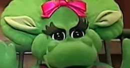 Baby Bop from Barney & Friends greets with enthusiasm, showcasing her green costume and playful personality.