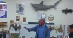 Instructor engaging with students in a workshop, showcasing woodworking skills with tools and materials in the background.