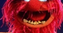 Vibrant red-haired Muppet character with an expressive face, showcasing playful animal vibes and energy.