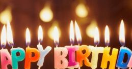 Colorful "Happy Birthday" candles atop a delicious cake, glowing with festive cheer for a joyful celebration.