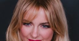 Mckenna Grace showcases glamorous wavy hair and vibrant makeup, exemplifying her youthful charm and star power.