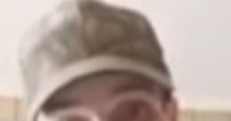 Person wearing a camo hat and shirt, possibly from Highstreet Paranormal: The Predator series, expressing curiosity.