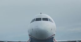 Airbus A320 flying low over water, showcasing advanced GPWS and alarm systems for enhanced safety during approach.