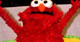 Elmo birthday cake with colorful decorations, featuring playful red frosting and a cheerful "Happy Birthday" message.