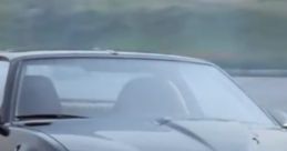 Classic KITT racing down the road, showcasing its iconic sleek black design and distinctive red scanner lights.