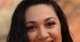 Kalani from 90 Day Fiancé smiles warmly, showcasing her long, dark hair against a natural background.