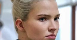 Focused portrait of a woman with sleek blonde hair and a serious expression, showcasing a powerful presence.