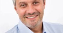 Smiling man in a blue shirt, embodying professionalism and approachability, perfect for corporate or business contexts.