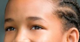 Jaden Smith smiles warmly, showcasing his role in The Karate Kid and capturing the essence of youthful determination.