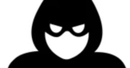 Silhouetted figure in a hoodie typing on a laptop, representing the concept of cybercrime and Indian scammer voices.