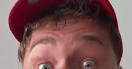 Excited expression of Timmy in a red cap, showcasing enthusiasm and a playful personality from Lucas Ivkovic's content.