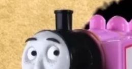 Smiling pink engine toy resembling Rosie from Robot Chicken, set against a textured beige background.