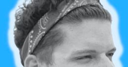 Young man with curly hair and bandana, smiling against a blue background, representing the creative vibe of Zack D Film.