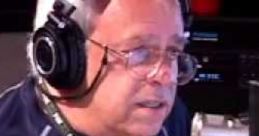 Larry Van Nuys speaking on air with headphones in a radio studio, focused on his broadcast and equipment.
