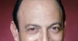 Mel Blanc smiling in a suit, known for his versatility and iconic voice work in animation. Celebrating his legacy in voice acting.