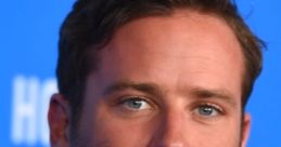 Armie Hammer at a public event, featuring his stylish attire and striking blue eyes, showcasing his charismatic presence.