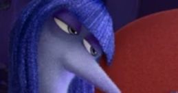 Inside Out character Ennui, with blue hair and a pensive expression, gazes at a phone while lounging on a red couch.