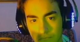 MrduarteXD deep in thought with headphones on, showcasing a vibrant green lighting atmosphere. Engaging content creator vibe.