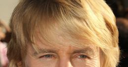 Owen C. Wilson at a film premiere, showcasing his signature tousled hair and sharp suit, exuding charm and charisma.