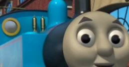 Cheerful Thomas the Tank Engine smiles brightly, showcasing his vibrant blue color and friendly expression in the railway station.