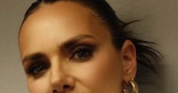 Stylish portrait of Esther S, showcasing elegant earrings and makeup, exuding confidence and sophistication.