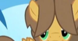 Young Hoops from My Little Pony, featuring a light brown pony with green eyes and playful expression against a blue background.