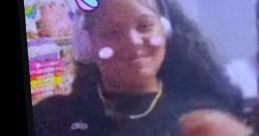 Smiling girl with a unicorn filter, wearing headphones and a black outfit, enjoying music and fun moments.