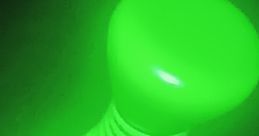 Glow-in-the-dark green toy resembling a dumbbell, ideal for interactive games like "Flick It" and playful activities.