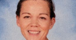 Smiling woman in an orange shirt, representing enthusiasm and positivity in an educational setting.
