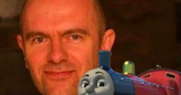 Rob Rackstraw, voice actor known for James in Thomas & Friends, smiling alongside animated character James the red engine.