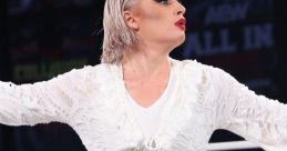 Toni Storm showcasing her AEW Women's World Championship in an elegant white outfit during an intense wrestling event.