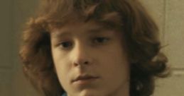 Finney from "Finney Evil 48," looking contemplative in a denim jacket, showcasing a vintage fashion style.