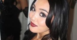 Roxanne Perez poses glamorously in a black dress with elegant makeup, showcasing her signature style.