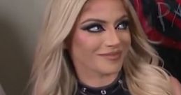 Alexa Bliss sporting a stylish black top with the phrase "We're Not Friends," showcasing her signature glam look.