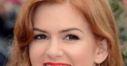 Isla Fisher smiling gracefully with long red hair, wearing a white dress and striking red lipstick at a public event.