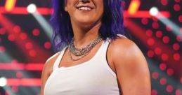Bayley smiles confidently in WWE NXT, showcasing her unique style with purple hair and a stylish outfit.