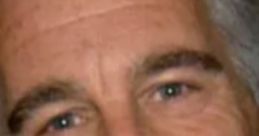 Close-up of a man with light skin, gray hair, and a subtle smile, showcasing his calm demeanor and confident presence.
