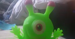 Colorful green Mack The Monster toy with round body, playful eyes, and spiky limbs, perfect for fun and imaginative playtime.