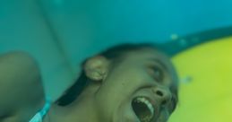 Girl enjoying a playful moment while sliding down a water slide, showcasing excitement and joy in vibrant colors.